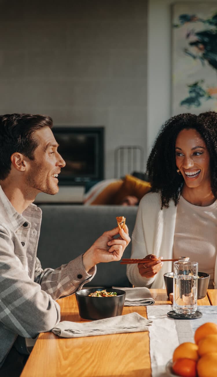 A man and woman sitting at a table enjoying a Tovala meal